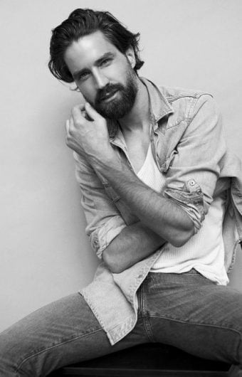 Male client dumbbell training at Roar Fitness with personal trainer w